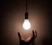 person holding white light bulb
