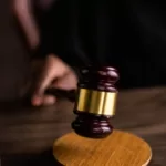 brown and gold gavel on brown wooden table
