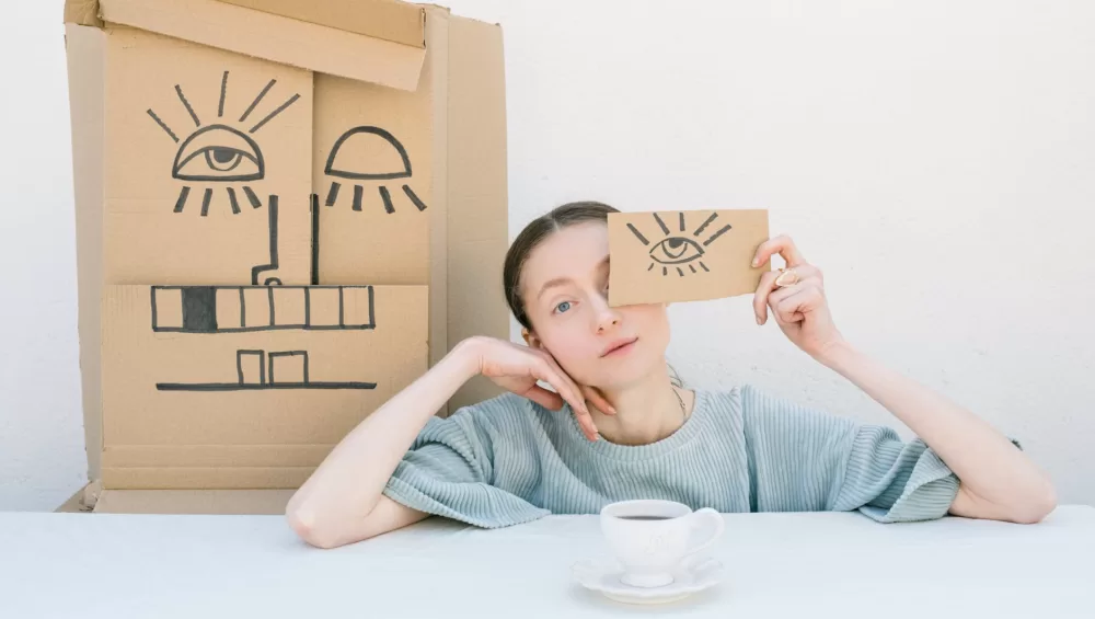 woman holding a cardboard box with a drawing