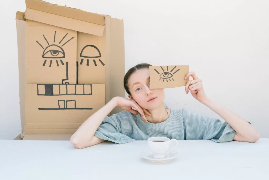 woman holding a cardboard box with a drawing