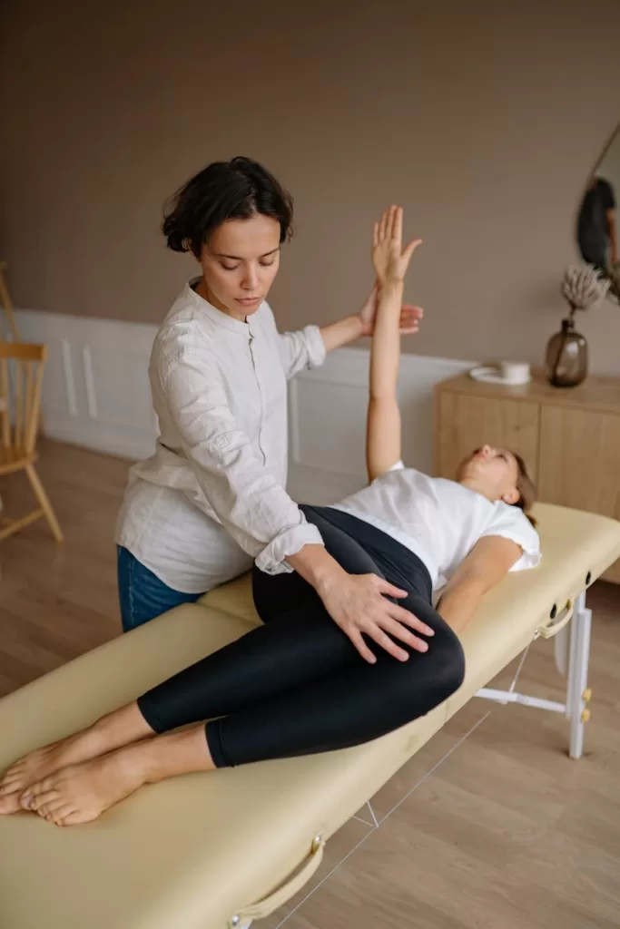 physiotherapist woman showing exercises to patient