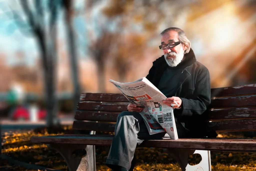 photo of man reading newspaper